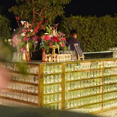 We design bars that become the centerpiece of your celebration. Our custom 'Bling Bar' is a testament to luxury and elegance, decked with hanging crystals and beautiful florals to create a truly glamorous focal point.