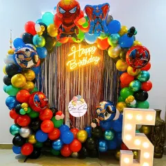 An action-packed superhero theme birthday decoration. This setup includes a full balloon ring with Spiderman and Superman foil balloons, a shimmer backdrop, and a light-up number '5'.