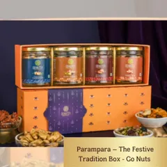 This 'Parampara' festive tradition box is a popular choice for wedding favors. It contains four jars of assorted premium nuts in a beautifully designed orange and purple box, blending traditional flavors with modern, elegant packaging.