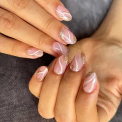 A sweet and swirly design in pink and white, with a touch of gold glitter for some sparkle. Perfect for short to medium length nails.