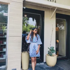 A slightly different pose in the same blue printed dress, showing how a simple outfit can look great from all angles.