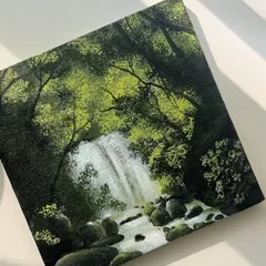 Lost in the woods. This is a finished acrylic painting of a waterfall hidden deep in a forest, with sunlight filtering through the canopy. It’s a piece that invites you to step into a calmer world.