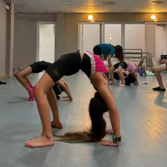 Strength and flexibility are built step by step. This photo captures a moment from our kids' jazz and ballet class, where students work together on their backbends. We create a positive atmosphere where every child is encouraged to try their best and celebrate their progress.