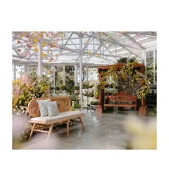 The Haldi setup, featuring a modern cane bench and a traditional carved swing, both adorned with delicate florals. This blend of contemporary and classic elements is a signature of my design style.