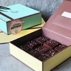 A box of our Millionaire Bars, ready for gifting. The tag "Sending this along with heaps of extreme HAPPINESS" perfectly captures the joy these bars bring.