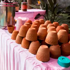 A close-up of the terracotta kullads, stacked and ready for hot chai. It's a small detail that evokes a lot of warmth and nostalgia.