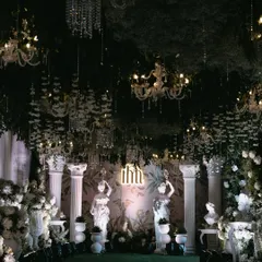 I designed this dramatic entryway to feel like a secret garden at night. A ceiling of dense greenery, hanging crystal chandeliers, and classical statues created an immersive and luxurious experience for guests.
