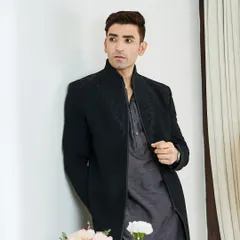 The full ensemble showcases the fusion of a traditional kurta length with a modern, structured jacket. This is for the man who isn't afraid to make a style statement.