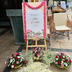 A personalized welcome sign for the parents-to-be at their Godh Bharai. We framed the elegant lotus-themed easel with a garland of fresh pink flowers and surrounded it with arrangements of roses and jasmine.