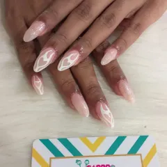 A softer take on the flame trend, this set features white flame outlines on a shimmery, nude base. The design on these long oval nails is both cool and elegant.