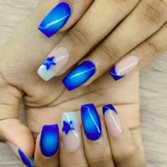 Reach for the stars with this celestial-themed set. We used a vibrant blue cat-eye effect polish and paired it with accent nails featuring a French tip and a single blue star on a white base.