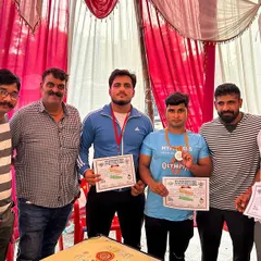 Standing with fellow medal winners at the NPC district powerlifting event. Hard work pays off.