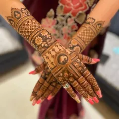 A beautiful example of a non-figurative bridal design. The hands are covered in a mix of geometric patterns, floral bands, and a central circular motif.