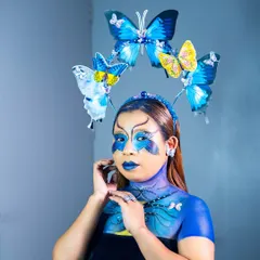 Another angle of the butterfly fantasy look, emphasizing the delicate details and the cohesive blend of face paint, accessories, and expression.