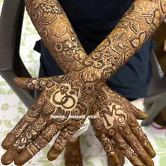 An engagement mehendi design to celebrate your special day. This look features the couple's initials and a prominent ring motif on the palm, surrounded by my favorite floral and paisley patterns that extend up the arm.