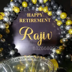 A closer look at the personalized 'Happy Retirement' backdrop. The gold lettering on the dark background, framed by the balloon arch, creates a classy and memorable photo spot.