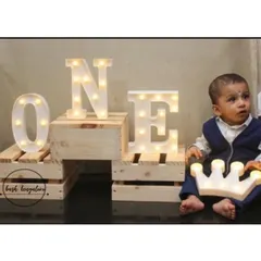 A little prince celebrating his first birthday with our light up props. The large 'ONE' marquee letters and illuminated crown create a perfect photo opportunity for this milestone.