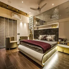 A contemporary bedroom design with a unique curved bed frame and integrated under-bed lighting. The headboard wall features etched glass panels and a decorative laser-cut screen.