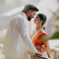 A soft and dreamy portrait of the couple on a balcony. The gentle light and their loving gaze create a feeling of pure romance and bliss.