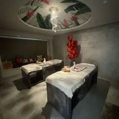 This is where you can truly escape and reconnect. My private couples' treatment room is a sanctuary designed for shared serenity, featuring two massage beds under a beautifully painted ceiling and soft, ambient lighting to create a romantic and peaceful atmosphere.