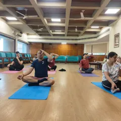 Here, students engage in Nadi Shodhana, or alternate nostril breathing. This fundamental pranayama technique is taught in my classes to purify the energy channels, balance the left and right hemispheres of the brain, and create a state of tranquility.
