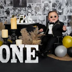 This little rockstar is turning one! We had a blast with this music-themed birthday shoot, complete with a mini piano, cool shades, and a whole lot of attitude.