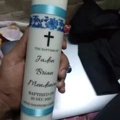 A clean and classic design for a baptism candle. This pillar candle for Jadon Brian Mendonca features a simple cross, the event details, and a decorative blue ribbon.