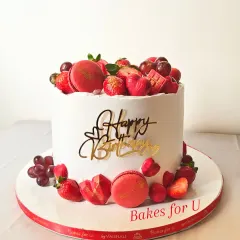 This vibrant birthday cake shows how I love to play with color using natural elements. The design features fresh strawberries, ruby chocolate hearts, and delicate macarons, all arranged on a smooth, white buttercream canvas.