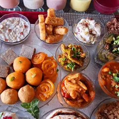 This image highlights the sweets and snacks section of the 56 Bhog. You can see dairy-free motichoor laddoos, jalebi, gurpara, and a creamy plant-based shrikhand, proving that indulgence can be cruelty-free.