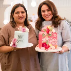 Posing with my pastel blue cake and another beautiful creation at a women's day event.