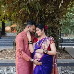 An intimate moment between the couple, framed by bamboo. Her beautiful purple saree and his traditional kurta create a look that is both elegant and deeply rooted in culture.