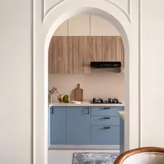 An arched entryway frames the view into this beautifully crafted kitchen, showing how I design spaces to flow seamlessly into one another. The arch adds an element of architectural interest to the home.