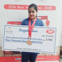 One of our young champions proudly displaying her medal and a prize of Rs. 5,100 at the Guns of Nation Grand Prix. We encourage our shooters to participate in competitions from an early age.