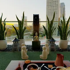 This Zen-themed balcony design brings a sense of peace high above the city. The space features low-maintenance snake plants, a calming water feature, and symbolic decor to create a perfect spot for meditation and gratitude.