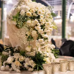 A close-up of a stunning white floral arrangement. I believe in using an abundance of fresh flowers to create a sense of luxury and romance.