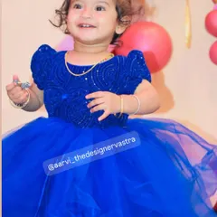 Isn't she adorable? This little princess is celebrating her birthday in a custom royal blue party frock with a sequined bodice.