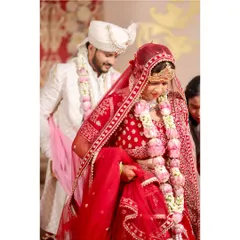 The bride and groom taking their first steps together during the pheras. This is a significant part of the wedding ceremony, symbolizing their journey forward as a married couple.