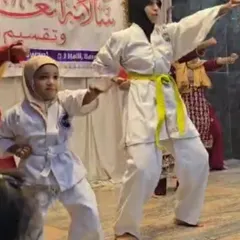A self-defense demonstration by my female black belt students for a school audience, showcasing practical techniques.