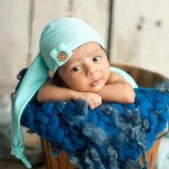 A sweet little one looking so peaceful in a rustic wooden bucket. I use a variety of props like this to add texture and warmth to my newborn portraits, always ensuring your baby is safe and comfortable.