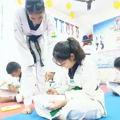 An senior student helps a junior with her written exam. Our team culture is about lifting each other up and sharing knowledge.