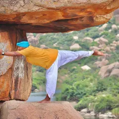 Exploring physical alignment while balancing on the rocks in Hampi. This practice is about creating straight lines and stacking bones to build a stable foundation, both in the posture and in life.