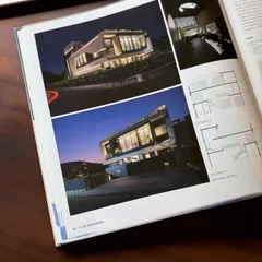 The publication includes detailed photographs and architectural drawings of Residence 100, showcasing its design from multiple perspectives.