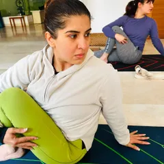 The focus and determination in our students is inspiring. Here, a student moves into Ardha Matsyendrasana (Half Lord of the Fishes Pose), a deep spinal twist that improves digestion and flexibility.