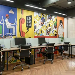 The open-plan workstation area is anything but boring. A full-wall graphic with comic-book style art adds a sense of fun and creativity to the main work zone.
