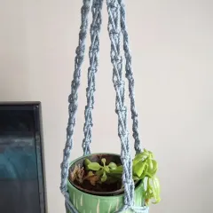 This plant hanger in a calming slate blue features a different, more open knotting style.
