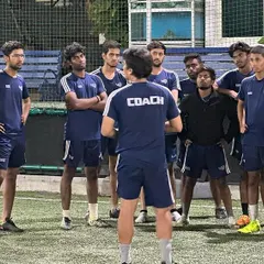 A team talk before the session begins. Our coaches work together to plan and execute training that is both effective and engaging for all our players.