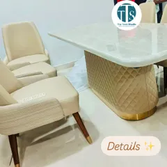 A close-up look at the details of this custom dining set. You can see the fine quilting on the upholstered table base, the smooth finish of the marble, and the combination of textures on the two-toned dining chairs.