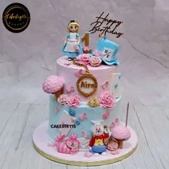 We went down the rabbit hole for this "Alice in Wonderland" themed first birthday cake. This two-tier choco-chip cake is full of whimsical details, including the White Rabbit, Cheshire Cat, and Mad Hatter's hat.