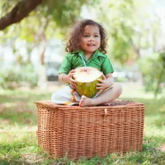 A happy smile from this little one during his outdoor photoshoot. The lush green background makes the colors of his outfit pop.