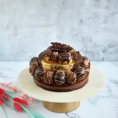 Our Desire 3 cake is a chocolate lover's dream, made with less-sweet dark couverture chocolate, praline frosting, and garnished with choux buns and 99% pure gold varak.